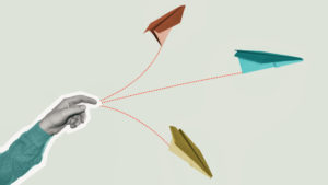 The person launches paper airplanes. Right direction concept.