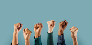 Group of people raising fists in solidarity and social activism
